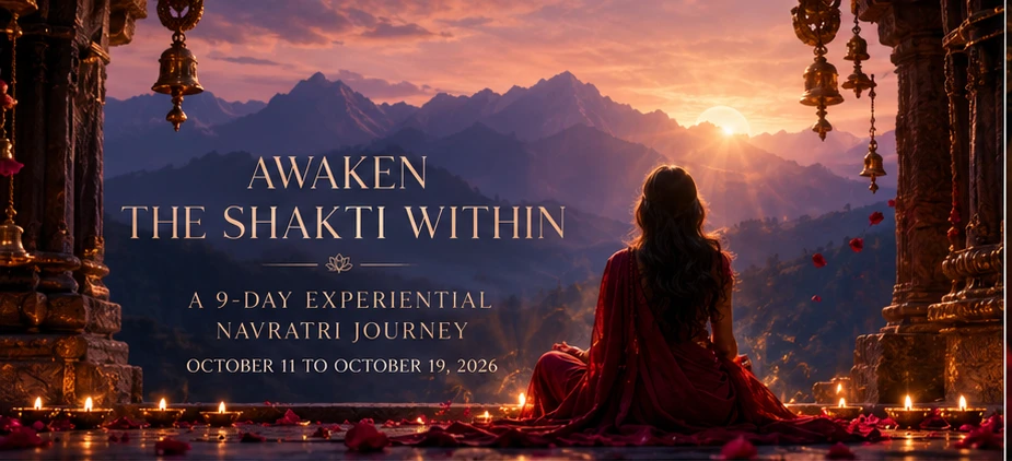 A woman seated at a Himalayan temple threshold at sunset, in meditation, with diyas and rose petals at her feet